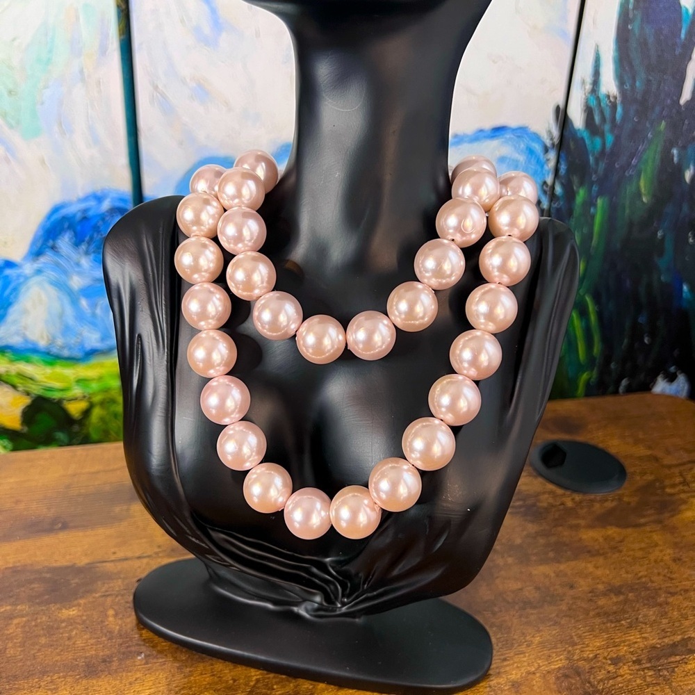 Baby pink, pearl, beaded belt with black bow.